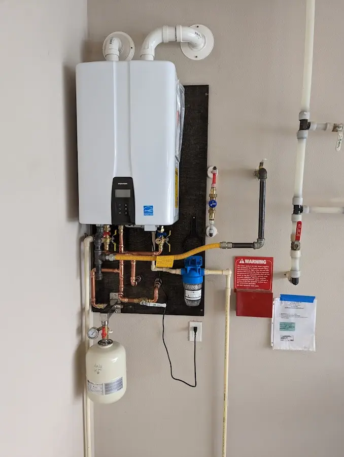 Professional plumber installing copper piping in a Tiptonville home